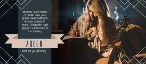 Auden acoustic guitars home page slider image with Carly Loasby writing next to guitar.